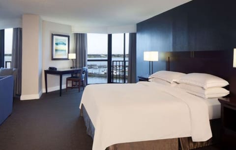 Wake up to serene water views from a plush king bed.