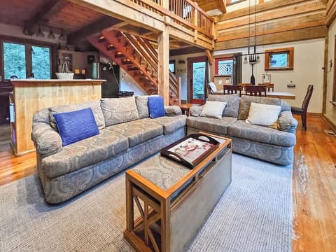 Couch and Love Seat next to Gas Fireplace with views of the river.  Smart TV for streaming.