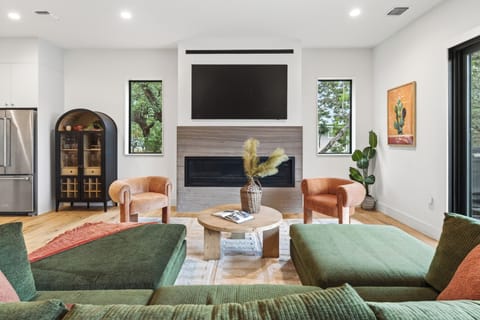 Bright, modern living room with fireplace and comfy seating.