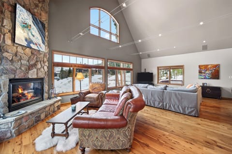High-angle view of the living area featuring a stone fireplace and vaulted ceilings.
