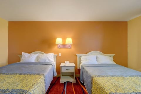 Drift off easily in crisp linens under warm bedside lighting.