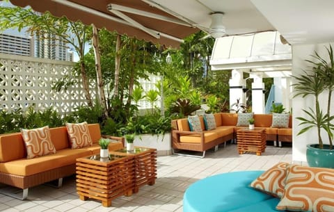 Sip morning coffee on the tropical patio beside swaying palms