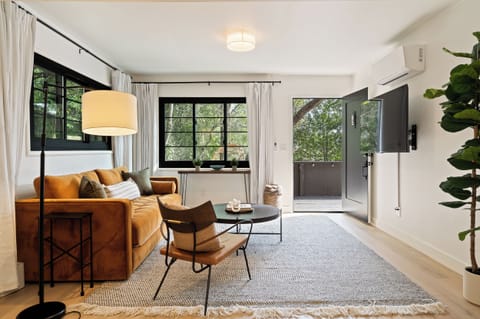 Design-forward living room with lounge seating + direct deck access