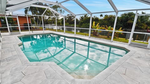 Screened pool area with water view, perfect for relaxing swim days in a quiet private setting