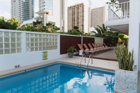 Dive into a sunlit pool oasis framed by skyline views
