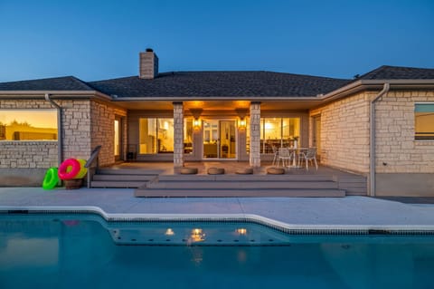 Perched above Lake Travis, this refined Lago Vista retreat is designed for effortless luxury and unforgettable views