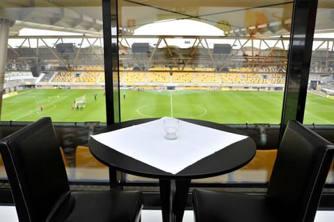 Sip cocktails while overlooking the stadium through panoramic windows.