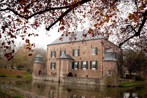 Discover storybook architecture framed by autumn leaves and water.