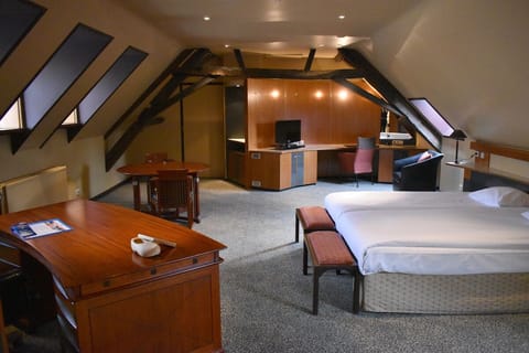 Stretch out in a spacious suite with warm attic charm.