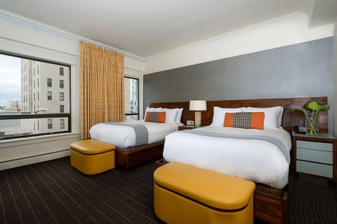 Wake up to daylight and city views from two comfy beds.