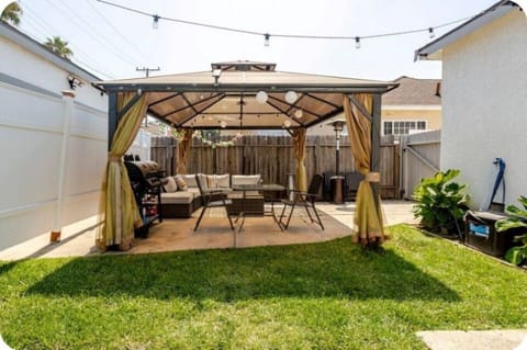 Private backyard oasis with BBQ, lounge seating, and covered patio — perfect for relaxing and entertaining