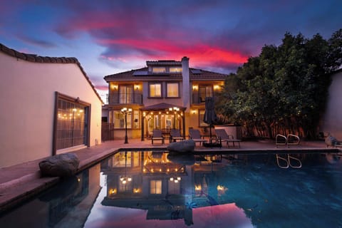 Backyard oasis with pool, lounge seating, and a covered patio perfect for relaxing evenings.
