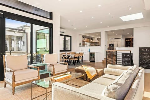 Bright and welcoming living space with comfortable seating, a dining area, and seamless connection to the kitchen and outdoor spaces.