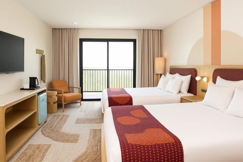 Unwind in bright double queens with breezy balcony views.