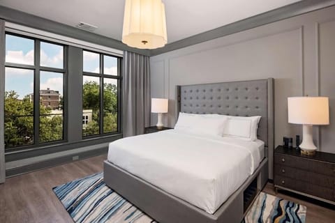 Unwind in crisp linens beside oversized windows and calm views.