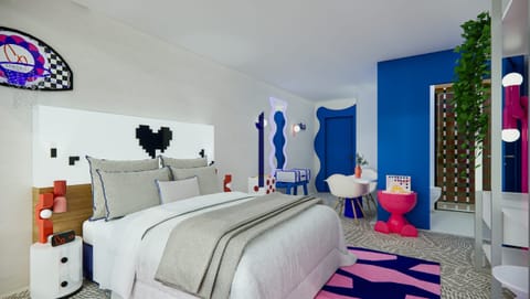 Unwind in a bold designer bedroom with playful pop-art flair.