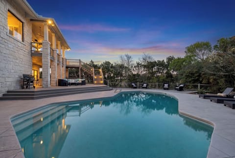 Private pool with Austin skyline views at twilight.