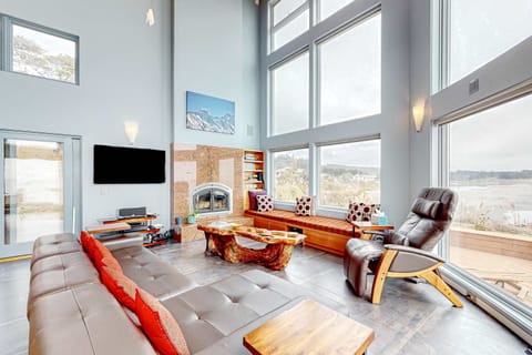 Imagine cozy evenings by the gas fireplace, where you can unwind and savor the breathtaking views through the floor-to-ceiling windows.