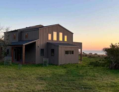 As the sun sets over the ocean, this coastal retreat welcomes you to unwind in its serene surroundings.