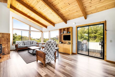 Morning light fills the living room, inviting you to unwind with a book or enjoy a cozy chat with loved ones in this inviting space.
