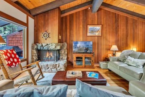 Living area with a Smart TV, fireplace, deck access