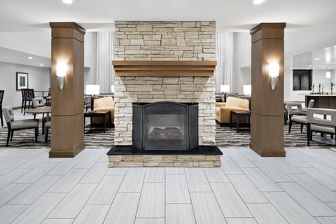 Cozy lounge with a stone fireplace and comfortable seating.