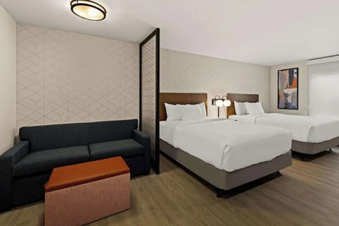 Settle into two plush beds with a cozy lounge corner.