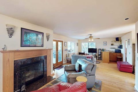 Settle into your sun-drenched living room where a stone fireplace anchors the open floor plan — perfect for unwinding after a day exploring Cloverdale wineries.