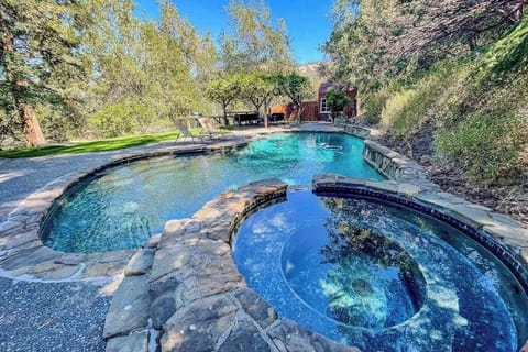 Slip into your private stone-edged pool and spa, tucked beneath towering trees in Cloverdale wine country — your personal oasis after a day of vineyard hopping.