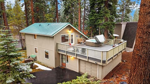 Cozy cabin with spacious deck, hot tub, and forest surroundings.