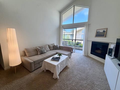 Spacious living area with cozy seating, 45` Apple Smart TV, and a warm, welcoming atmosphere perfect for unwinding after a day in LA.