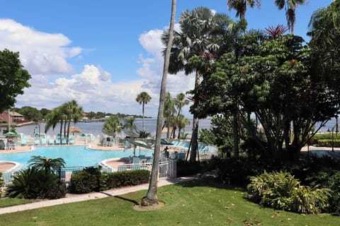 Stroll through lush grounds framing the glittering waterfront pool.
