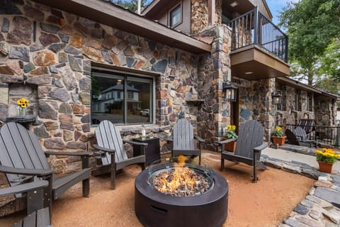 Front Outdoor Lounge Space with Adirondack Chairs and Propane Fire pit.