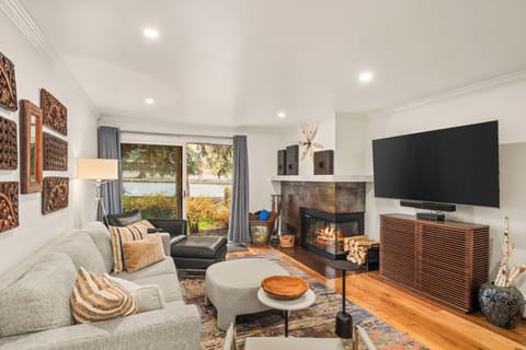 Living room with private porch with Aspen Mountain views, wood-burning fireplace, smart TV, and sofa bed.