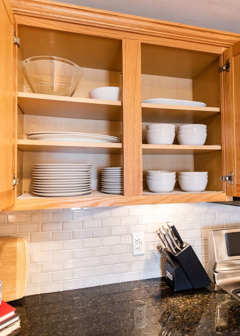 Upscale appliances with dual ovens, refrigerator with water in the door, microwave, dishwasher, and Keurig Duo. Includes all dishes and glassware with seating for 6.