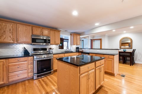 Upscale appliances with dual ovens, refrigerator with water in the door, microwave, dishwasher, and Keurig Duo. Includes all dishes and glassware with seating for 6.