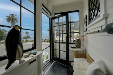 Front enclosed porch sitting area. Enjoy ocean breezes with a sliding screen.