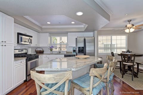 Kitchen is upgraded with island and bar stools
