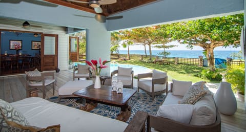Back patio with beach entry infinity edge pool overlooking the Caribbean Sea