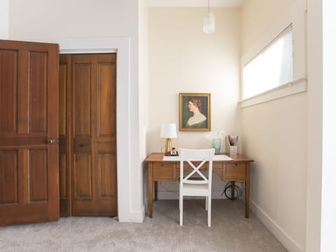 Private office space in a bedroom with privacy door, and en suite full bathroom