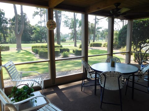 SCREENED PORCH WITH CEILING FAN OVERLOOKING THE 9TH TEE HARBOUR TOWN GOLF COURSE
