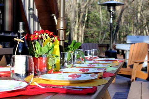 The table (seats 14) on the 40' deck w/ Adirondack chairs, outdoor heaters & BBQ