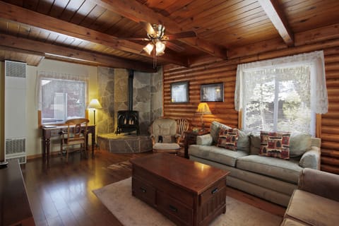 Beautiful living room with Tahoe Stone Hearth and original log walls.