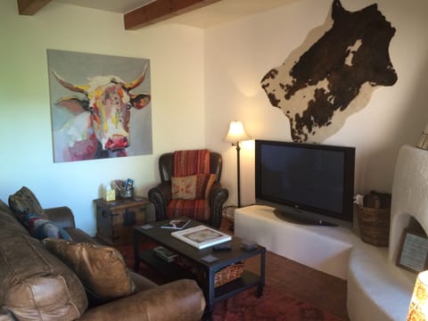 Living room with New leather queen sleeper sofa. Meet Perri, our resident cow. 