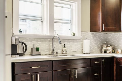 Beautiful full kitchen with gorgeous view of front lawn and courtyard