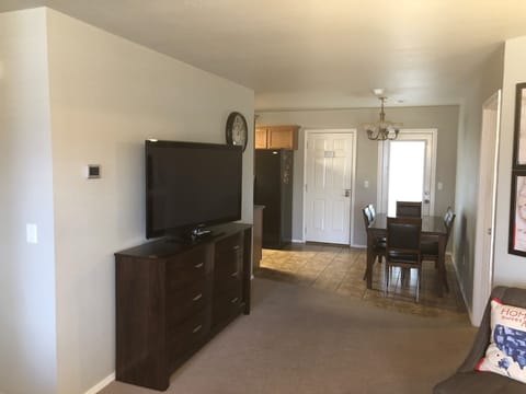 The 50 inch flatscreen TV is visible from the living and dining areas.