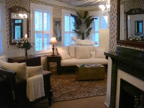 The spacious living room features a tented ceiling, British Colonial style furnishings and two fireplaces.