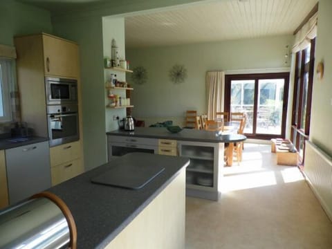 open plan living space accessing deck and gardens great views