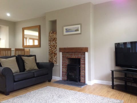 Spacious open plan living area with log burning stove