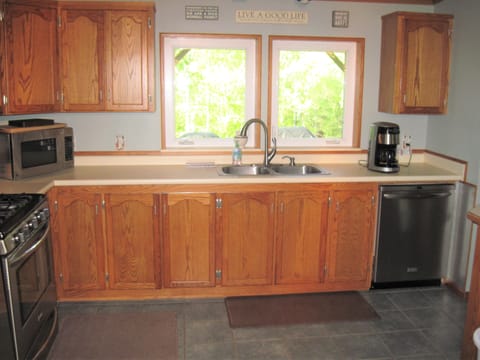 Furnished kitchen including dishwasher, microwave and coffee pot